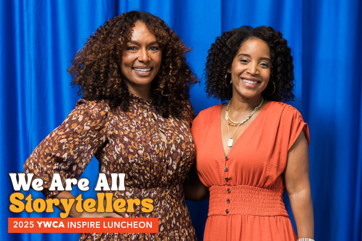 A photo of Janet Mock and Angela Poe Russell standing in front of a vibrant blue background