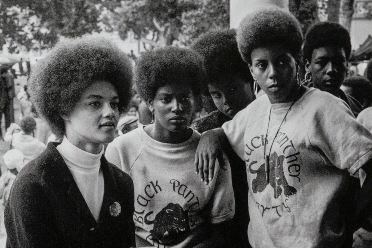 Oakland, California: Kathleen Cleaver, Communications Secretary and first female member of the Party’s decision-making Central Committee, talks with Black Panthers from Los Angeles who came to the “Free Huey” rally in DeFremery Park (named by the Panthers Bobby Hutton Park) in West Oakland, July 28, 1968. Stephen Shames (American, born in 1947) Photograph, archival pigment print, * Gift of Lizbeth and George Krupp * © 2023, Stephen Shames * Courtesy Museum of Fine Arts, Boston